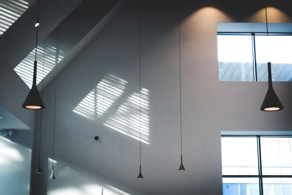 Contemporary indoor architecture showcasing minimalistic lighting and geometric shadows.